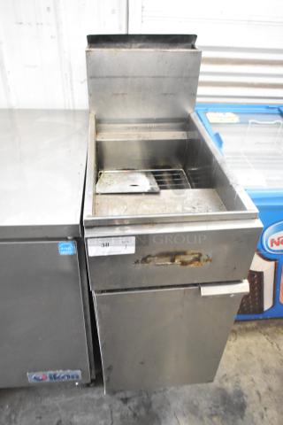 Stainless steel commercial floor-style gas-powered deep fat fryer, visible wear, label numbered 38, ideal for heavy-duty use.