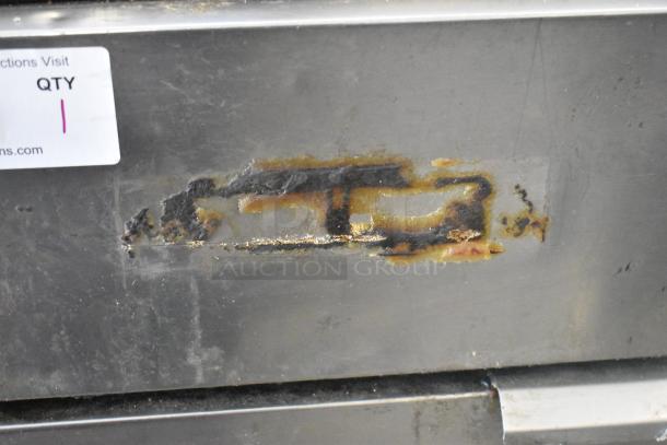 Stainless steel commercial gas fryer with visible rust patches and wear, featuring a quantity tag labeled "QTY 1."