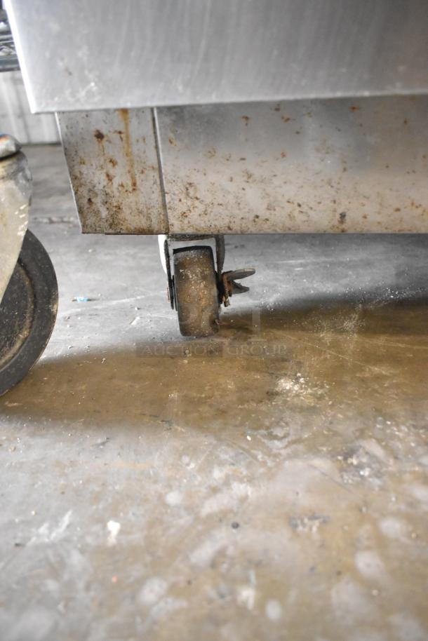 Ikon IUC28R stainless steel undercounter freezer on casters, displays visible rust and wear, 115V, 1 phase.