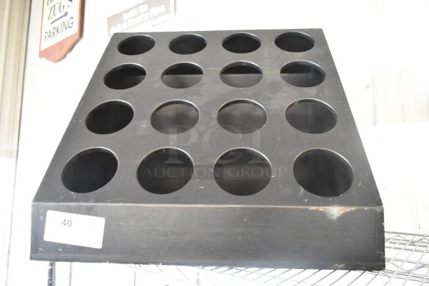 Black Poly 16 Cut Out Stand, features 16 circular cutouts in a pyramid shape. Slight wear visible, tag marked "40 QTY 1".