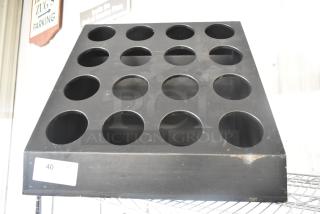 Black Poly 16 Cut Out Stand, features 16 circular cutouts in a pyramid shape. Slight wear visible, tag marked "40 QTY 1".