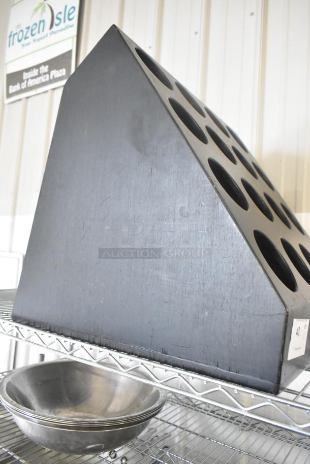 Black Poly 16 Cut Out Stand with circular holes, used condition; on a metal shelf with stainless steel bowls.