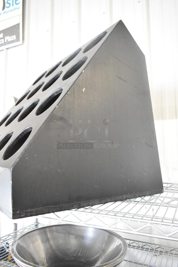 Black Poly 16 Cut Out Stand, features 16 circular cutouts. Slight wear visible, sturdy display functionality.