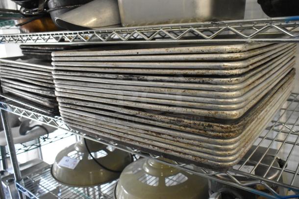 Tiered lot with metal baking pans stacked on a wire shelf. Items show signs of use with rust and wear. Various kitchenware visible.