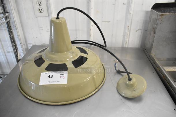 Two metal light fixtures, olive green, with black vent details and wiring. Auction label "43, QTY x2" on fixture.