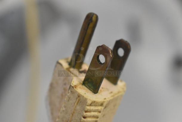 Close-up of a three-prong power plug for a KitchenAid KSM5OP/KM25G 5 Quart Dough Mixer, showing slight wear.