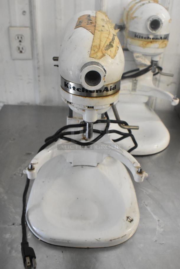 3 KitchenAid 5 Qt mixers with visible wear, 115V. Includes 2 dough hooks, 1 paddle. Tape marks on top, cords attached.