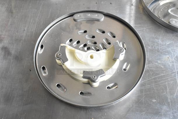 8 KitchenAid metal food processor blades, varying designs, stainless steel, used condition, suitable for precise cutting tasks.