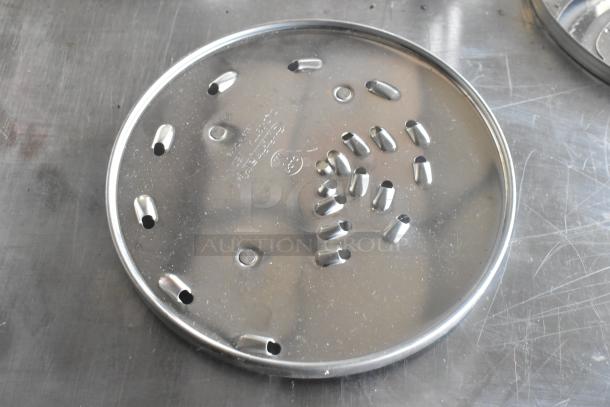 KitchenAid metal food processor blade, shiny surface, multiple openings, used condition, enhancing slicing efficiency.