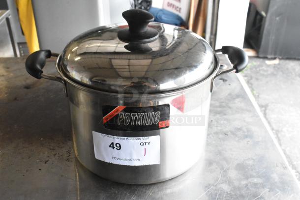 Potking stainless steel stock pot with lid, black handles. Label shows model name; good condition. Auction lot number 49.