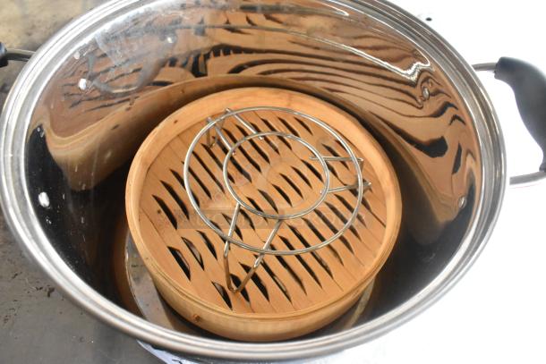 Potking Metal Stock Pot includes lid, bamboo steamer insert, and metal rack. Shiny finish, excellent condition.