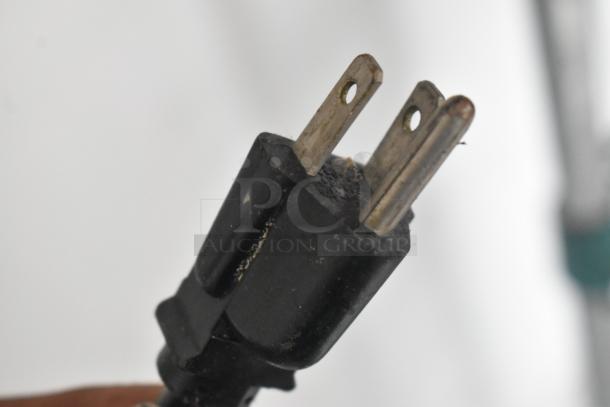 Close-up of a black two-prong electrical plug, connected to the KitchenAid Metal Countertop 5 Quart Planetary Dough Mixer.