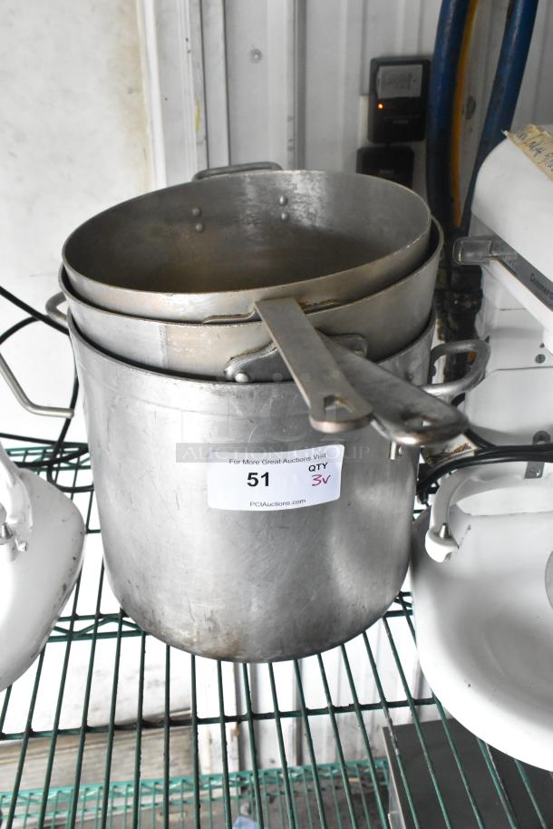 Three metal cookware items: a stock pot and two sauce pans, stacked. Label indicates "Qty 3." Some wear visible.