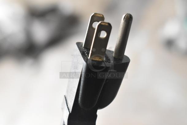 A close-up of a standard three-pronged electrical plug for a KitchenAid KM25G dough mixer.