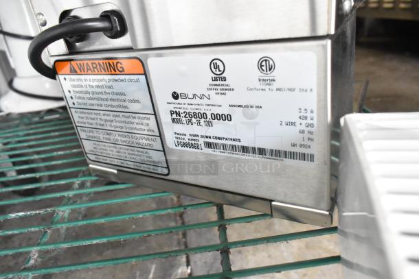 2024 Bunn LPG-2E stainless steel commercial coffee bean grinder, 120V, 1 phase, with safety and compliance labels visible.