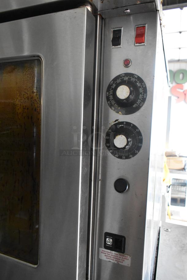 Blodgett stainless steel commercial convection oven with view-through doors, metal racks, and thermostatic controls on casters.