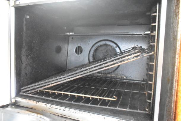Blodgett stainless steel commercial convection oven with view-through doors, metal racks, and thermostatic controls. Visible wear.