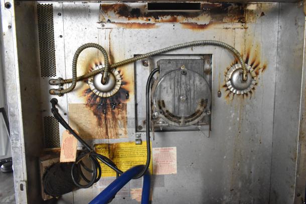 Back view of a Blodgett commercial gas convection oven, showing wiring and gas connections. Notices and warnings are visible.