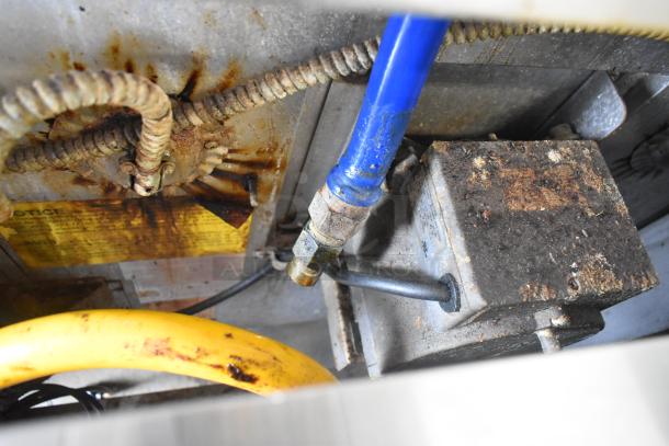 Close-up of gas connectors and rusted components on a Blodgett SHO-100-G convection oven, highlighting wear and condition.