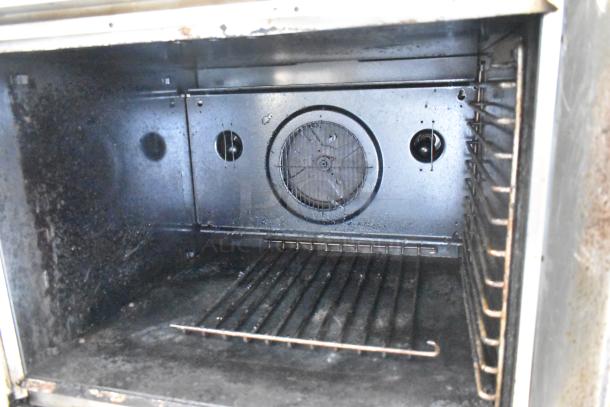Blodgett stainless steel commercial convection oven interior with metal racks and fan, in used condition.