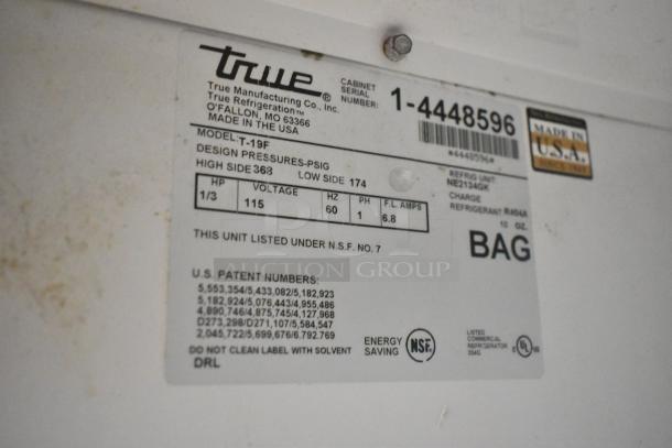 True T-19F stainless steel commercial freezer label. Shows model, voltage, phase, NSF certification, and made in USA.