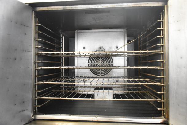 American Range Majestic stainless steel commercial convection oven interior, featuring solid doors and racks.
