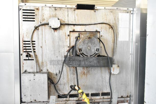 Back view of American Range Majestic stainless steel convection oven showing wiring and metal surface with signs of wear.