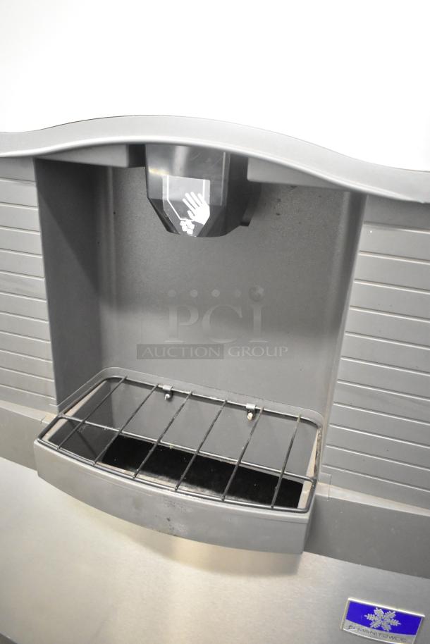Stainless steel Scotsman Prodigy C0530SW-1C ice head on Manitowoc bin, 115V, 1 phase. Visible hand symbol on dispenser.