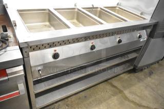 Stainless Steel 4 Well Steam Table with Under Shelf and Casters, featuring control knobs and sturdy construction.