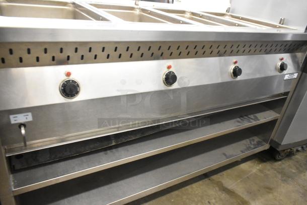 Stainless steel commercial 4 well steam table with under shelf on casters, featuring control knobs and ventilation slots.
