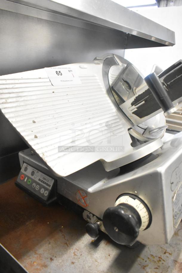 Bizerba SE 12 D US commercial meat slicer, metal, 120V, 1 phase. Features adjustable blade, control panel, and use markings.