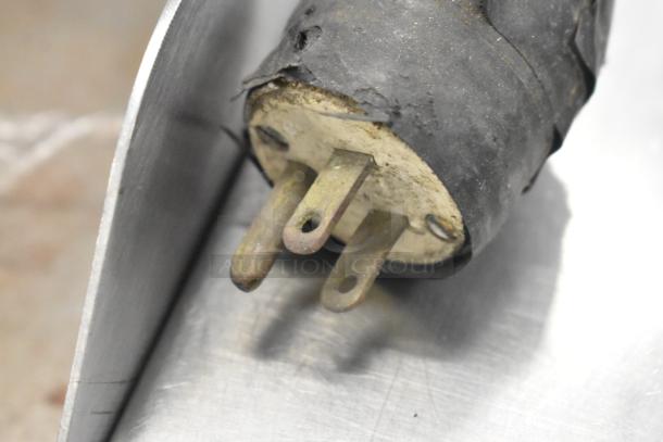Frayed plug of a Bizerba SE 12 D US meat slicer, showing wear, highlighting electrical safety concerns.