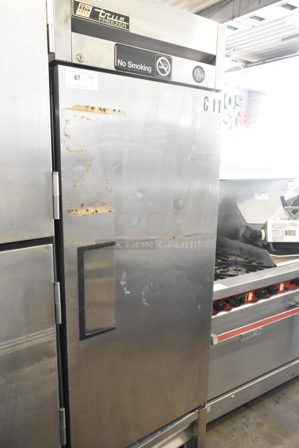 True T-23F stainless steel commercial single-door cooler, visible wear, 115 volts, 1 phase, 'No Smoking' label.