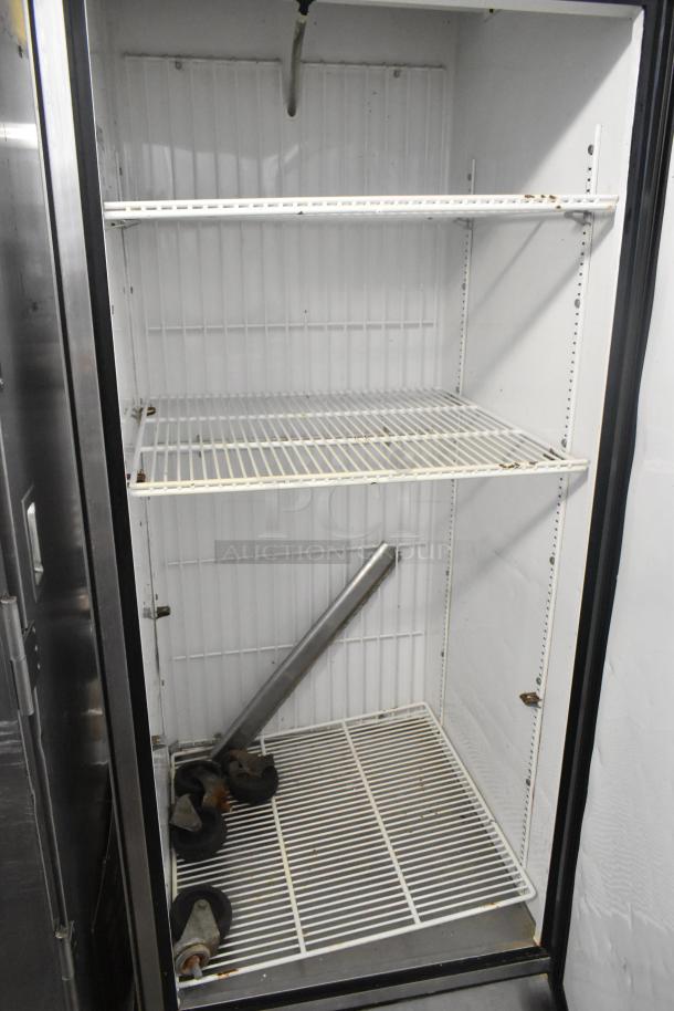 True T-23F stainless steel single door reach-in cooler, 115 volts, interior shelves visible, minor wear shown.