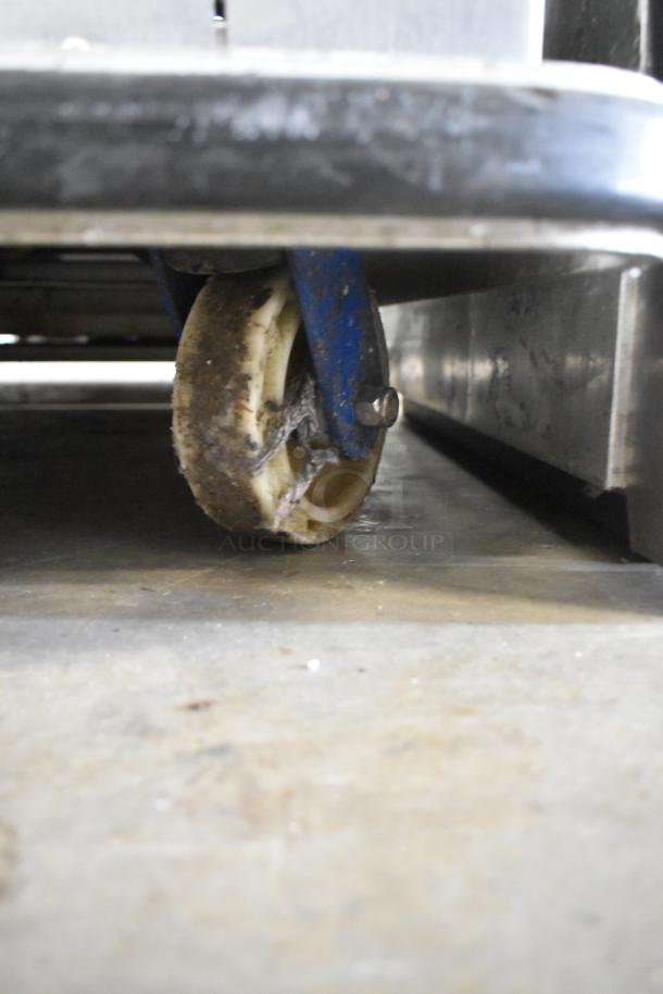 Traulsen RAC-37 stainless steel commercial cooler caster, showing wear and dirt. Model on commercial casters, 120V, 1 Phase.