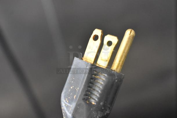 Close-up of a three-prong electrical plug for the Traulsen RAC-37 commercial cooler, 120 volts, 1 phase.