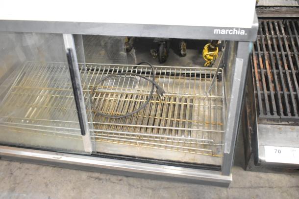 Marchia MHCC136 metal commercial countertop heated display case, used condition, 115 volts, branding visible, interior racks shown.