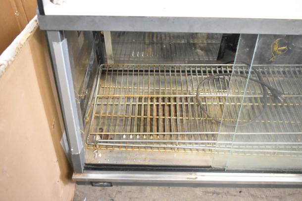Marchia MHCC136 metal commercial heated display case, glass front, interior shelves, 115V, 1 phase, used condition.