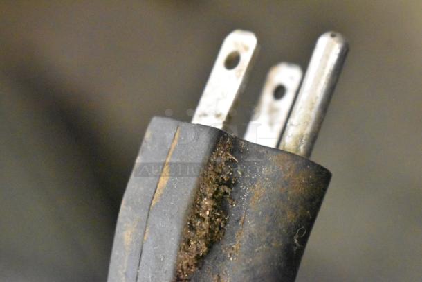 Close-up of a worn electrical plug for Marchia MHCC136 heated display case, showing frayed, dirty insulation.
