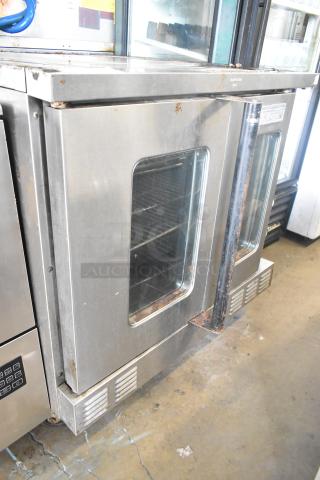 US Range stainless steel commercial convection oven with view-through doors, metal racks, thermostatic controls, visible wear.