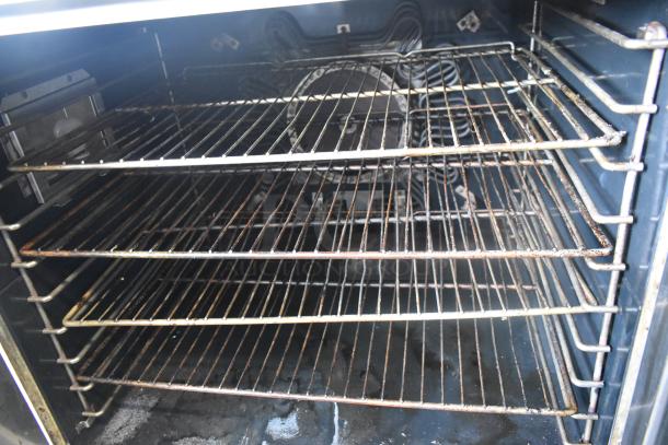 US Range stainless steel commercial convection oven interior with metal racks and visible thermostatic controls.
