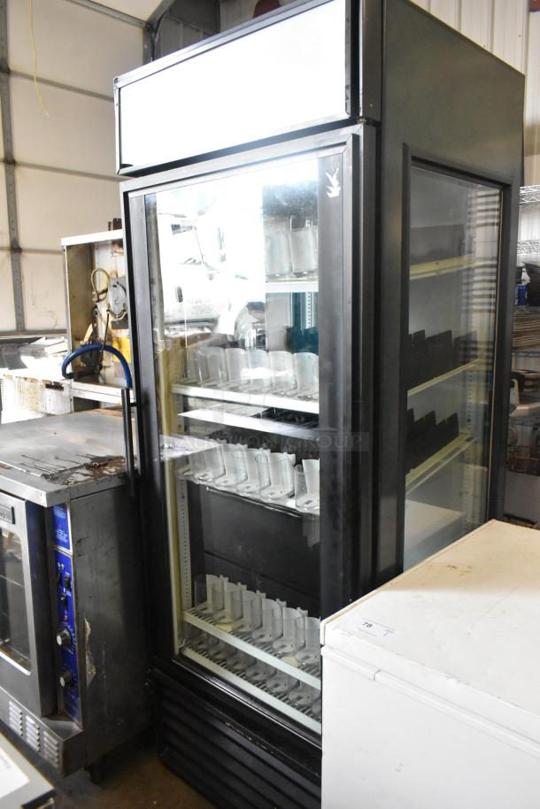 True GEM-26 commercial single door cooler, black metal, with poly coated racks and drink sliders. 115V, 1 phase.