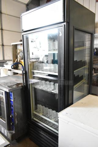 True GEM-26 commercial single door cooler, black metal, with poly coated racks and drink sliders. 115V, 1 phase.
