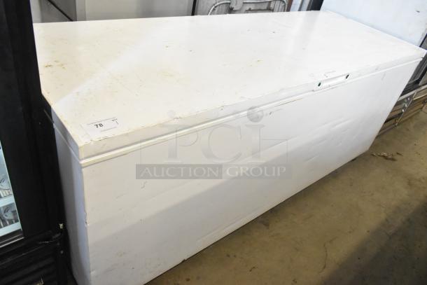 Frigidaire FFFC25M4TW chest freezer, hinge lid, 115V, 1 phase. White exterior, signs of wear, auction tag visible.
