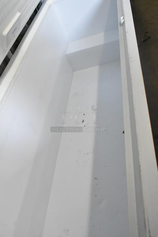 Frigidaire FFFC25M4TW chest freezer with hinge lid, 115 volts, 1 phase, interior view, clean condition.