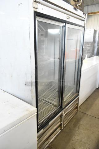 Leader ESLS54SC metal commercial 2-door reach-in cooler merchandiser, 115 volts, 1 phase, visible wear on exterior.