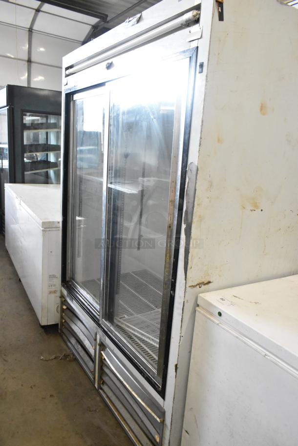 Leader ESLS54SC metal commercial 2-door reach-in cooler merchandiser, 115 volts, 1 phase, showing signs of wear.