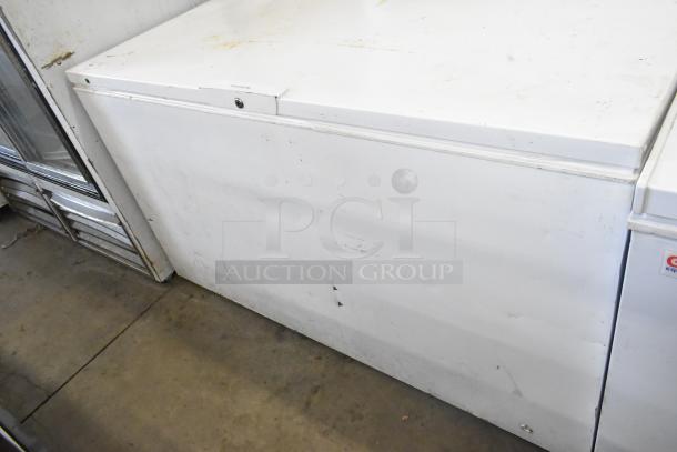 Frigidaire FFFC18M4RWA chest freezer with hinge lid, 115 volts, 1 phase. Visible wear on white exterior.