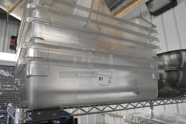 Lot of poly clear bins and metal bowls stacked on metal shelving. Label indicates quantity of 13. Good condition.