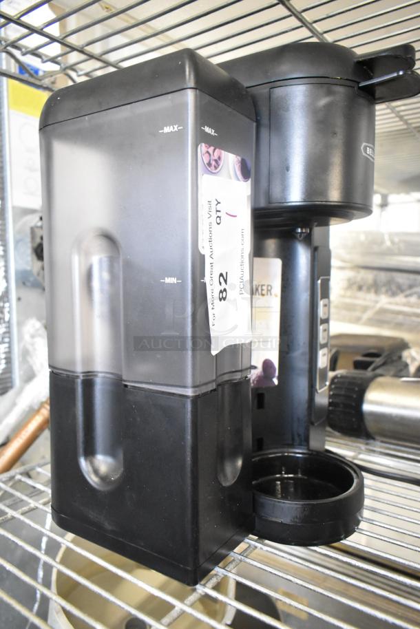 Bella TSK-1187R5B countertop single cup coffee machine, 120V, in used condition. Visible auction label and water level markings.
